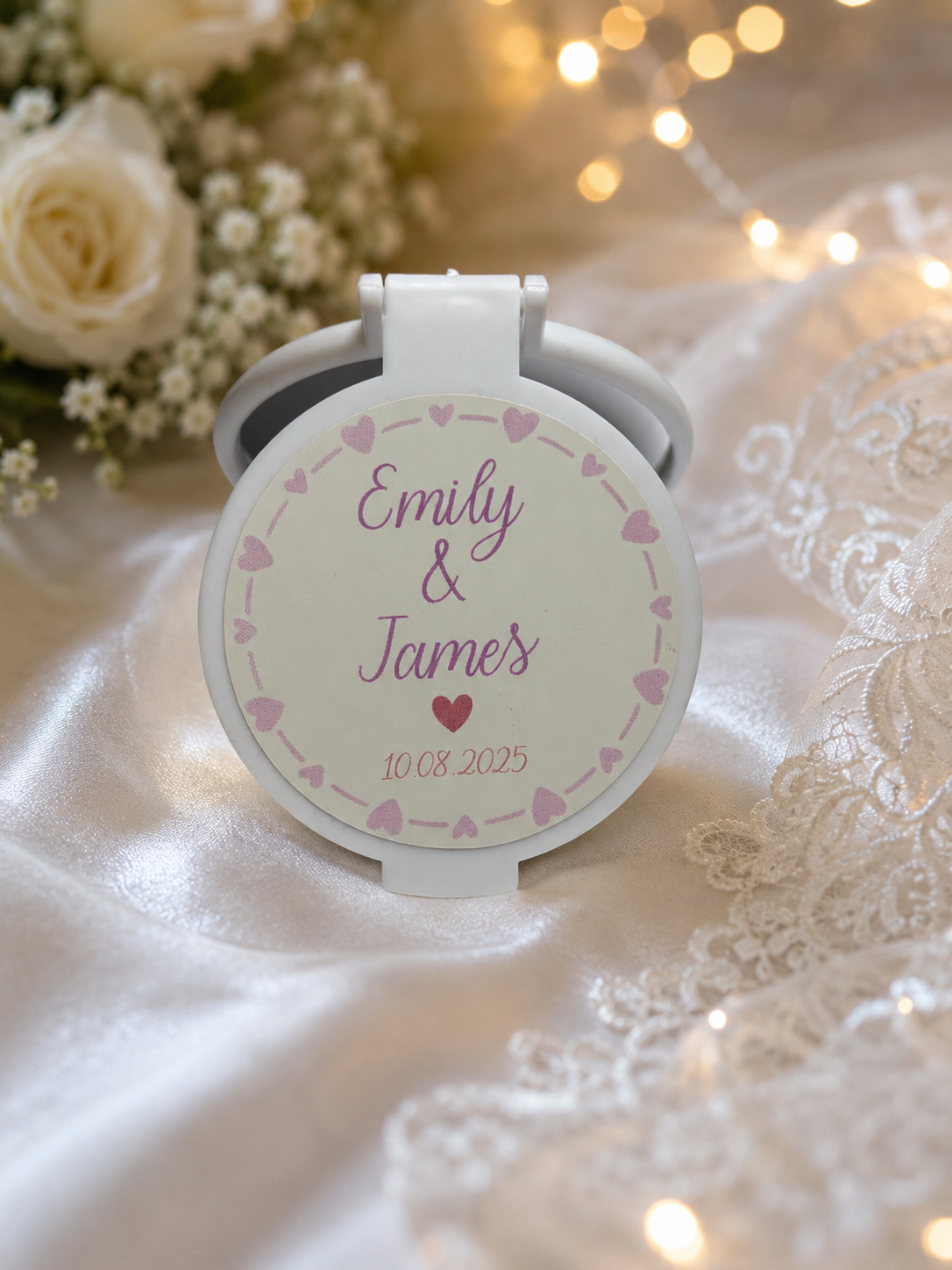 Personalised wedding compact mirror favour with pink heart border design, featuring Emily & James and wedding date
