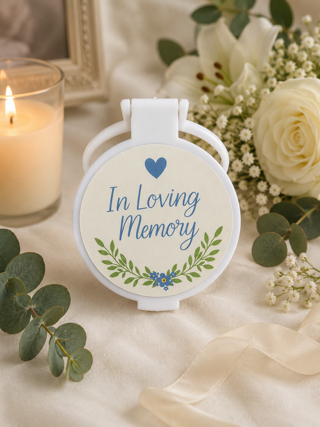 Personalised In Loving Memory memorial compact mirror featuring blue lettering, a heart, green foliage and delicate blue flowers.