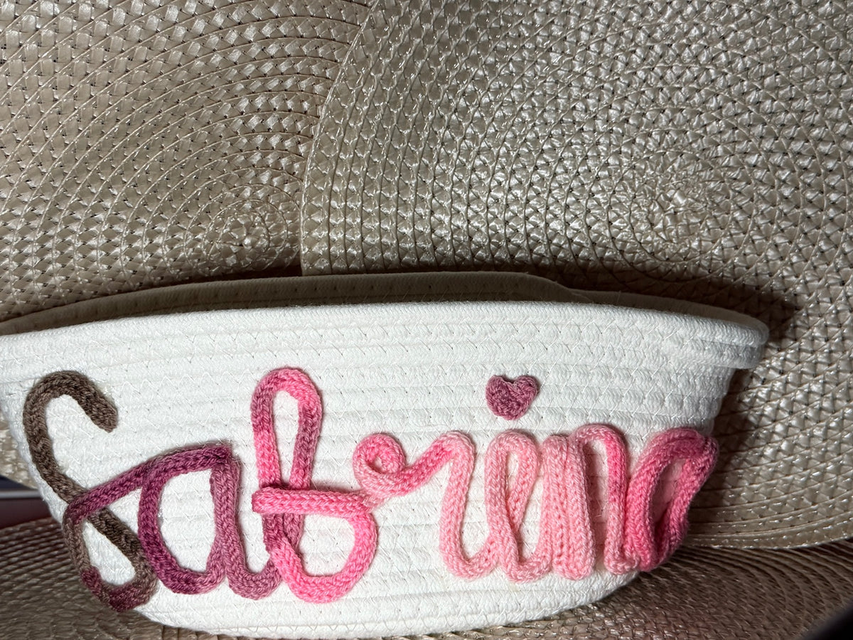 Personalised woven storage basket with a handmade pink and brown Tricotin name design