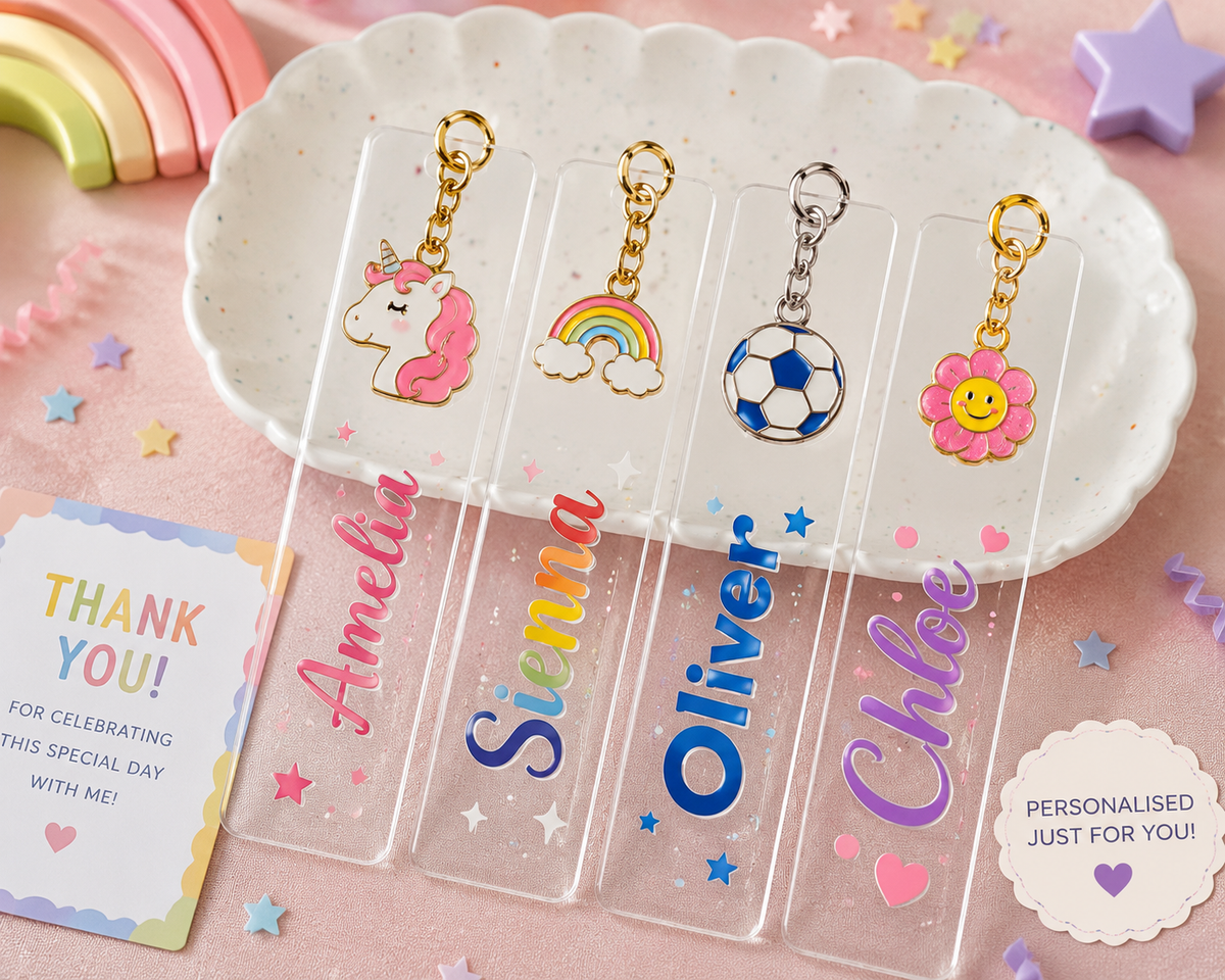 Personalised acrylic bookmark keychain favours for kids showing colourful names Amelia, Sienna, Oliver and Chloe with unicorn, rainbow, football and flower enamel charms